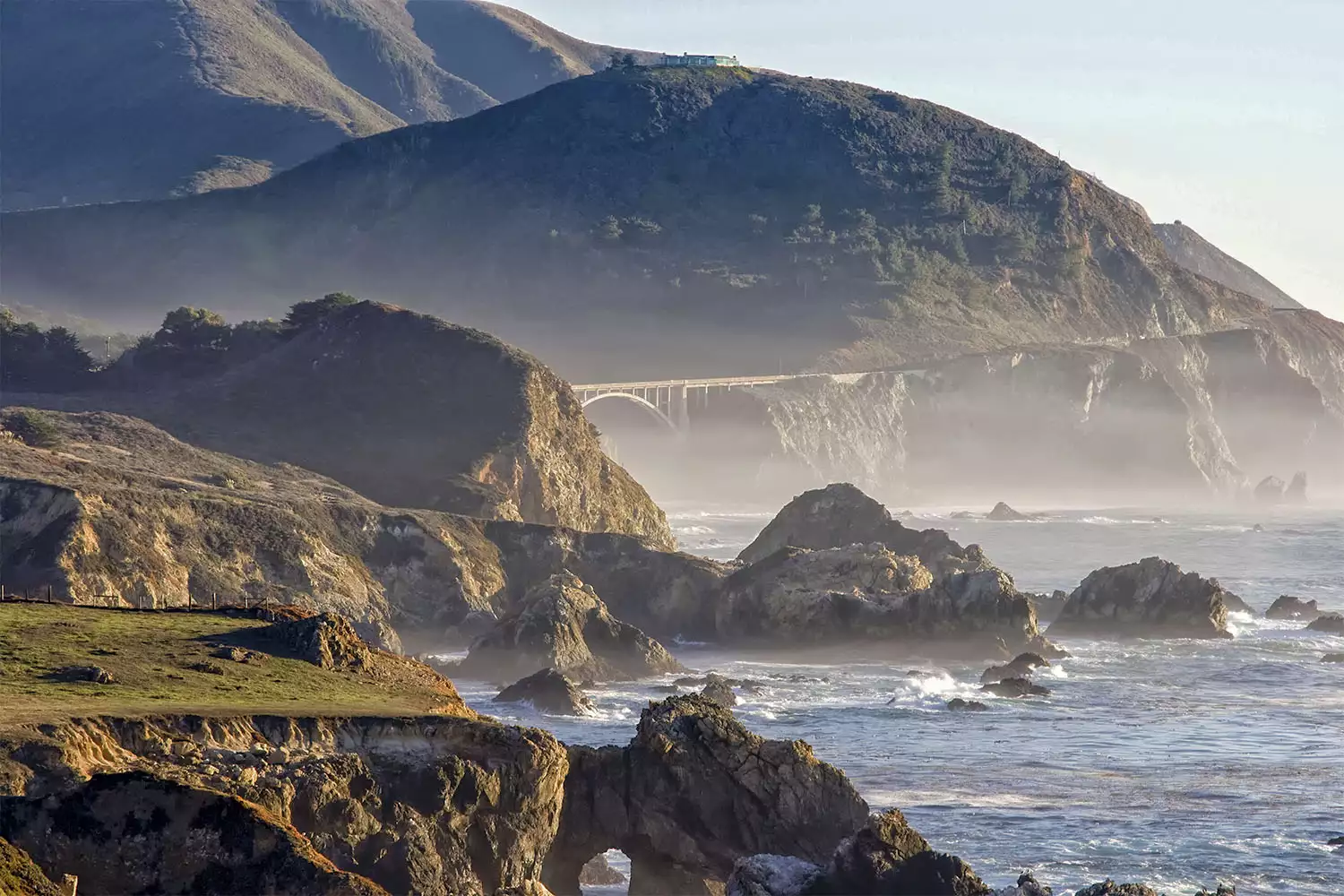 The misty and rocky coast of Big Sur on a partially cloudy day in California