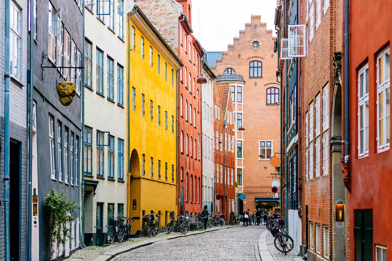 Colorful buildings on a cobbled road lined with bicycles