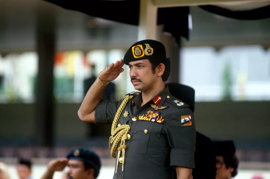 Sultan of Brunei, Hassanal Bolkiah, saluting at an event
