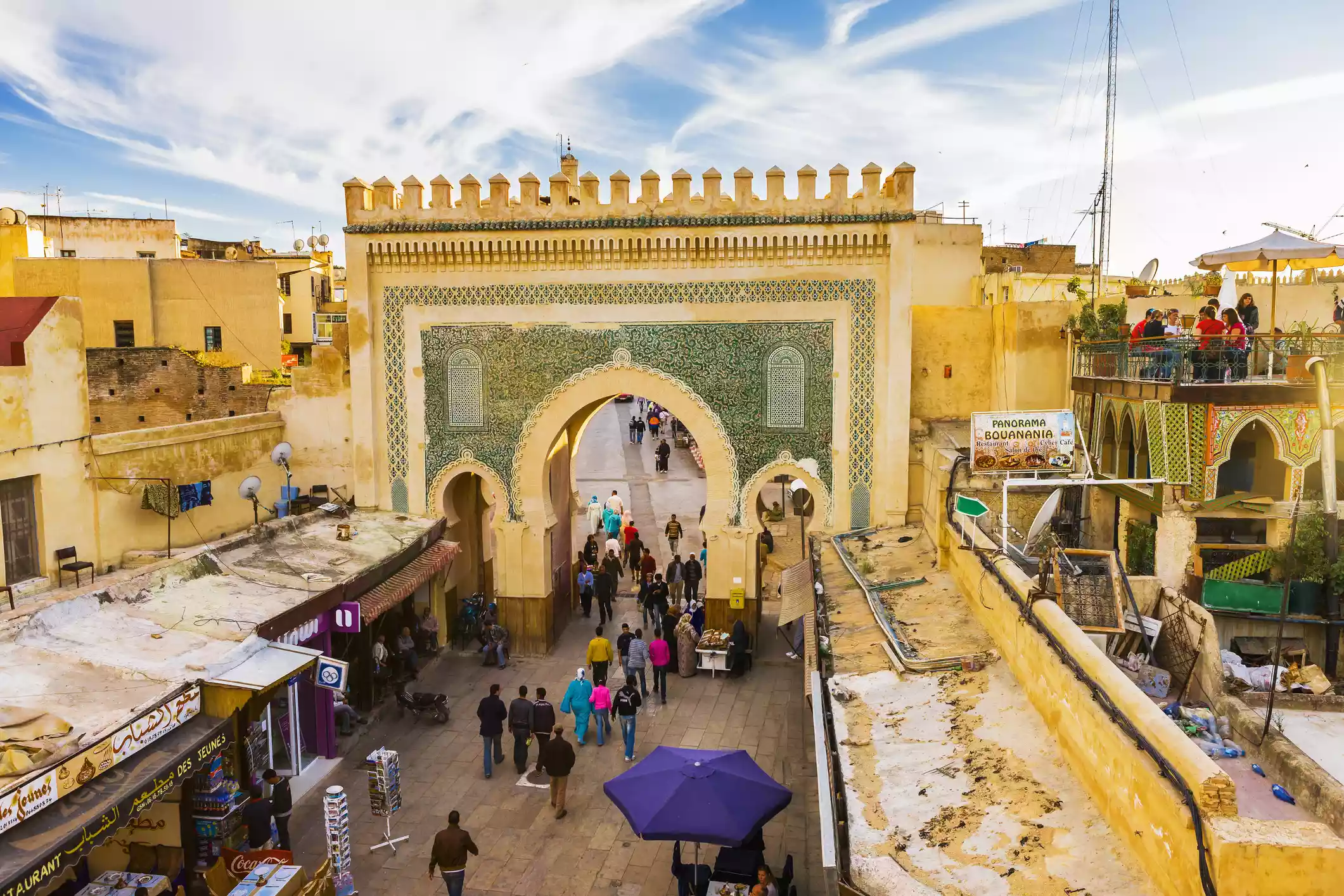 People walking through arch in Old Fez