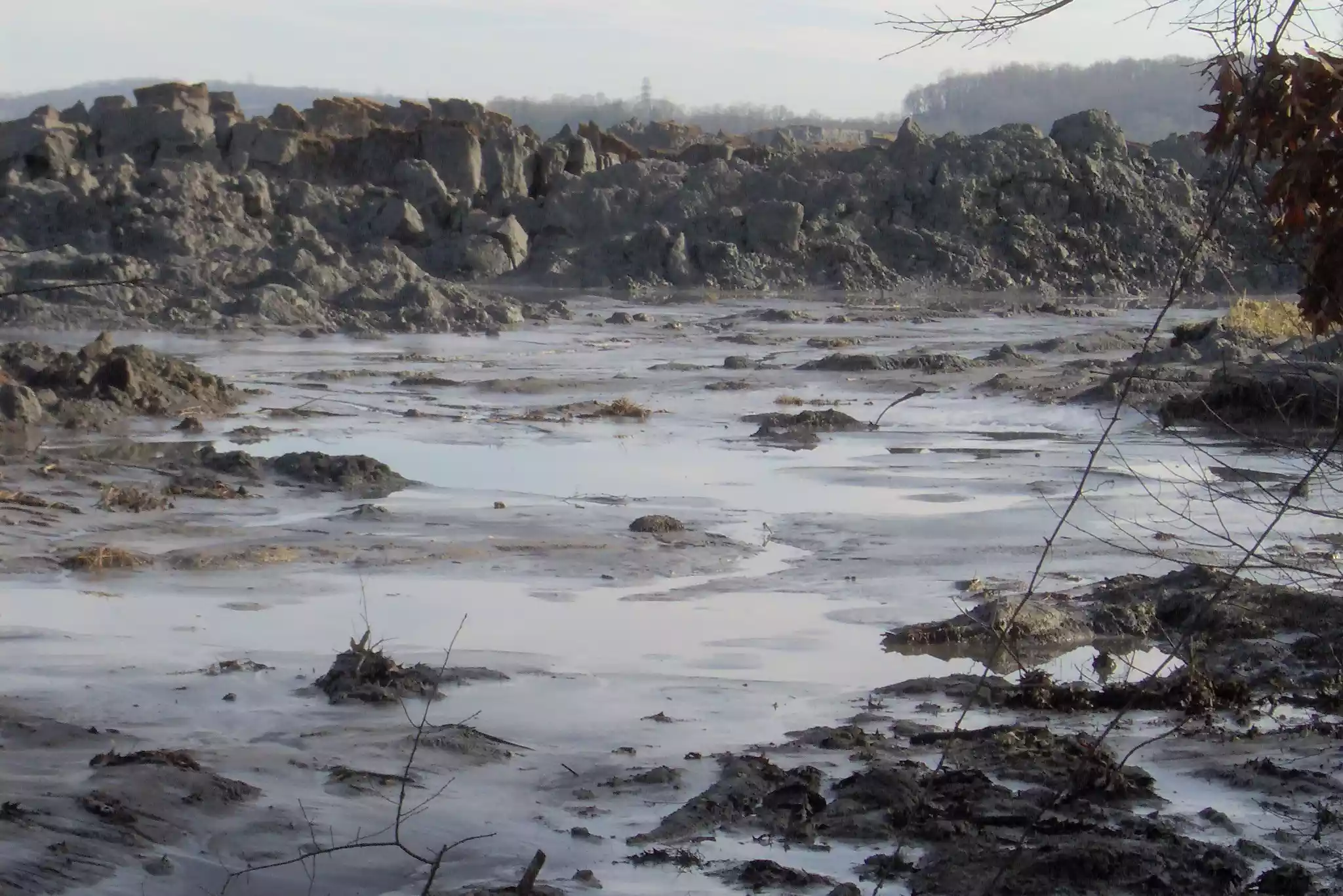Rocky landscape covered with grey slurry of coal ash