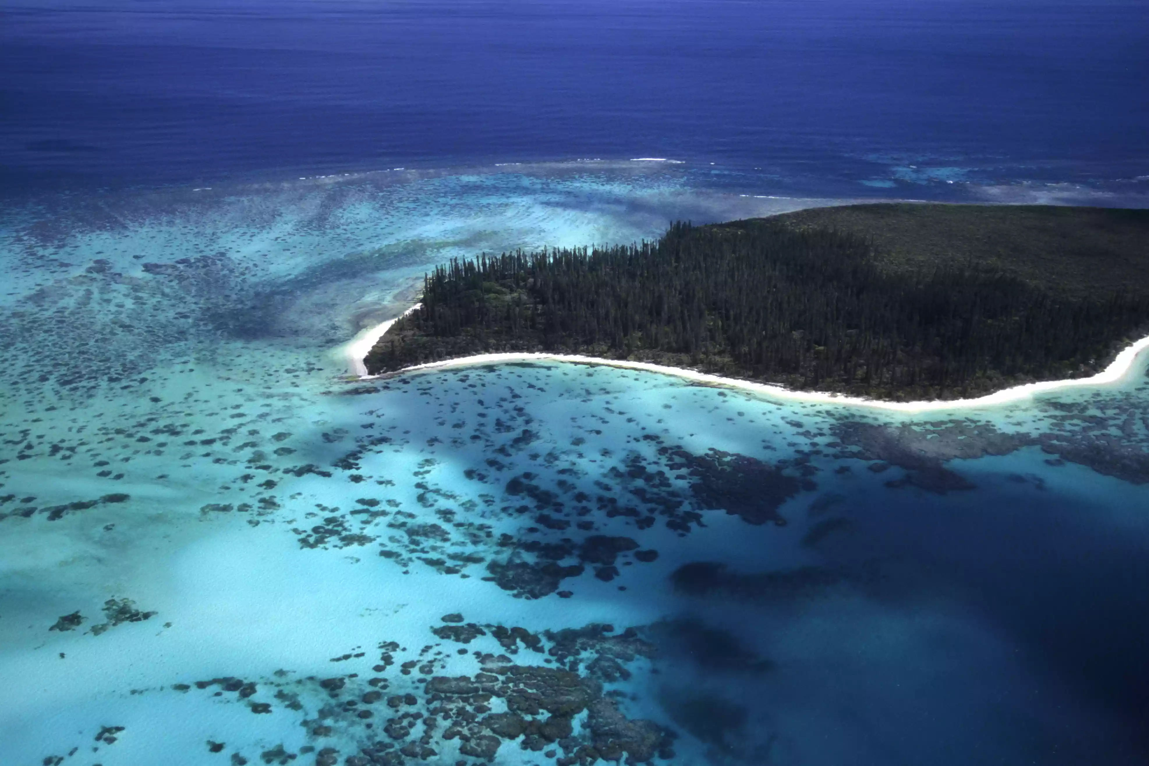 Aerial view of New Caledonia island surrounded by blue water