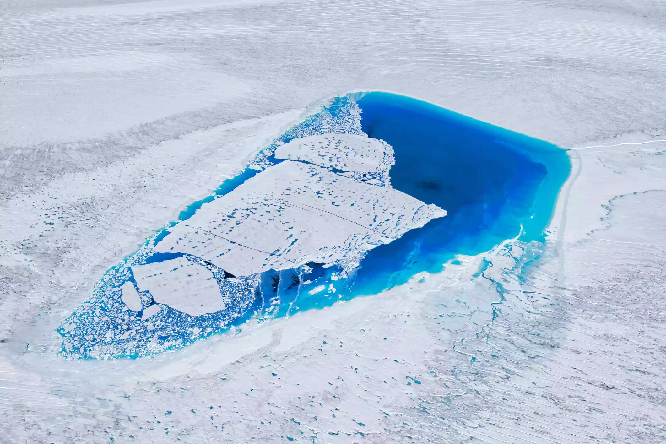 A brilliant blue lake on the Greenland Ice Sheet