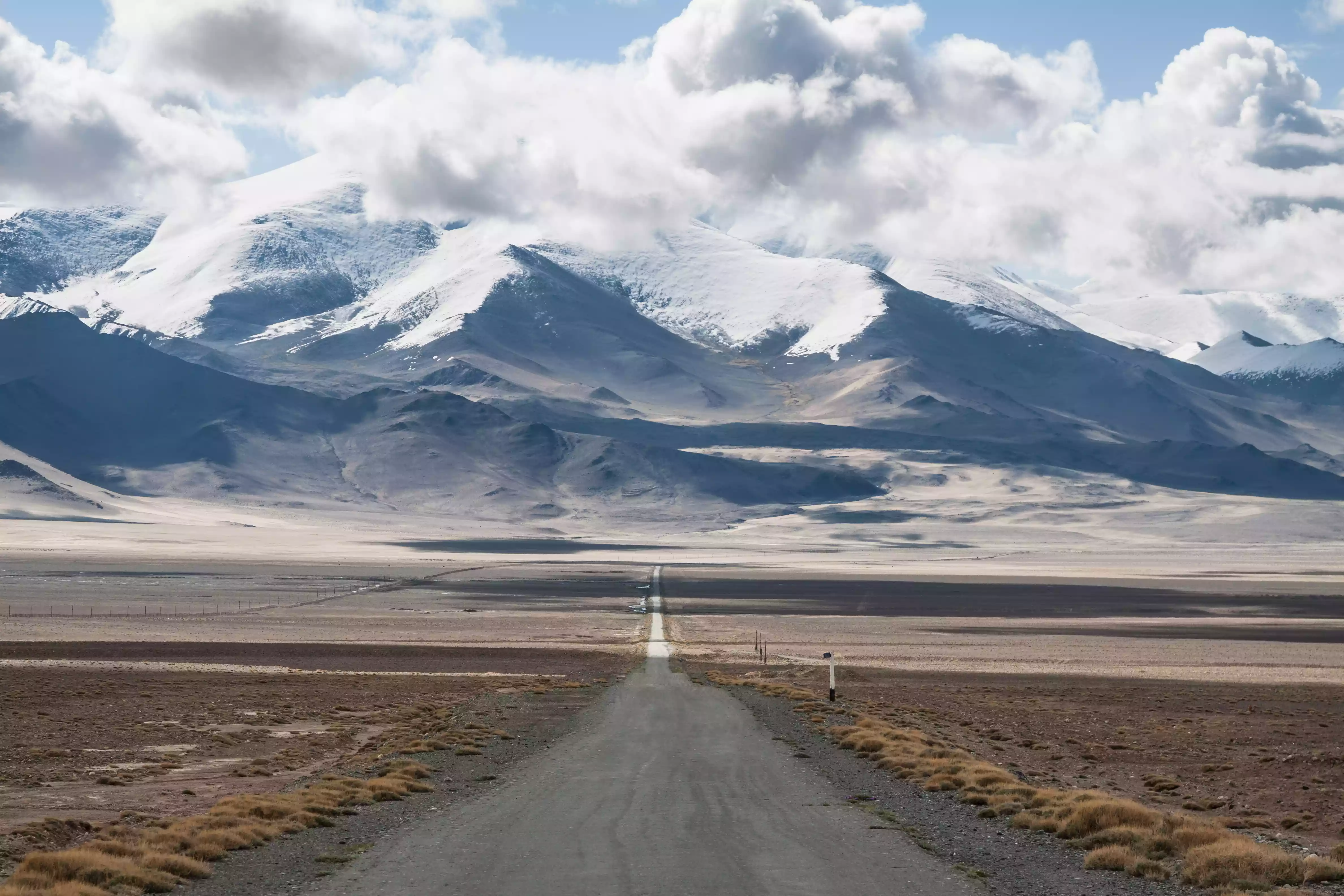 Pamir Highway in Tajikistan with the Pamir Mountains looming in the background