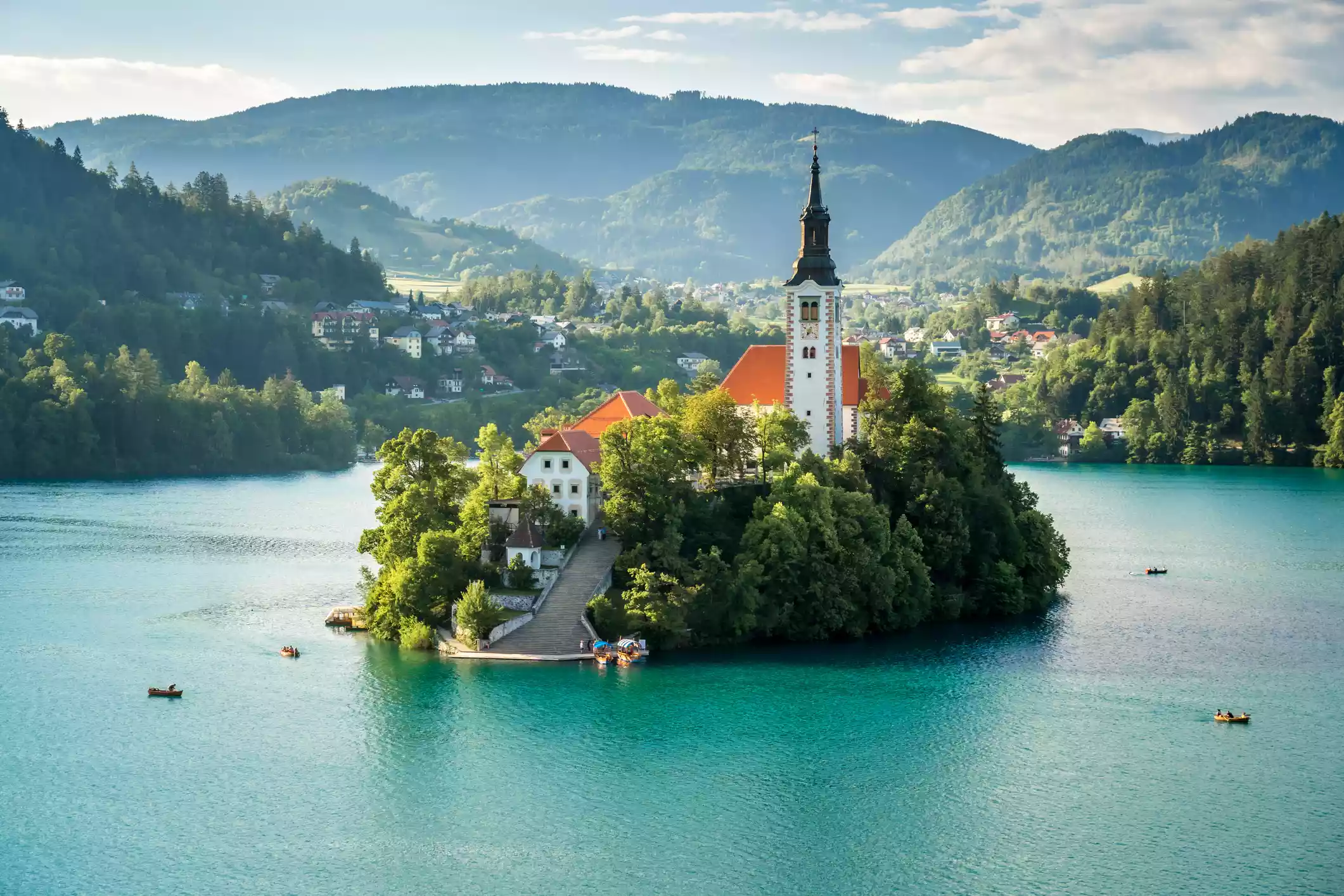 Church-topped island against mountains in Bled, Slovenia