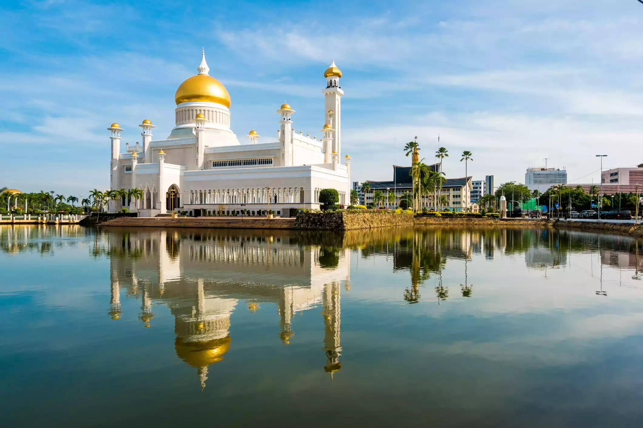 White and gold mosque surrounded by water in Brunei