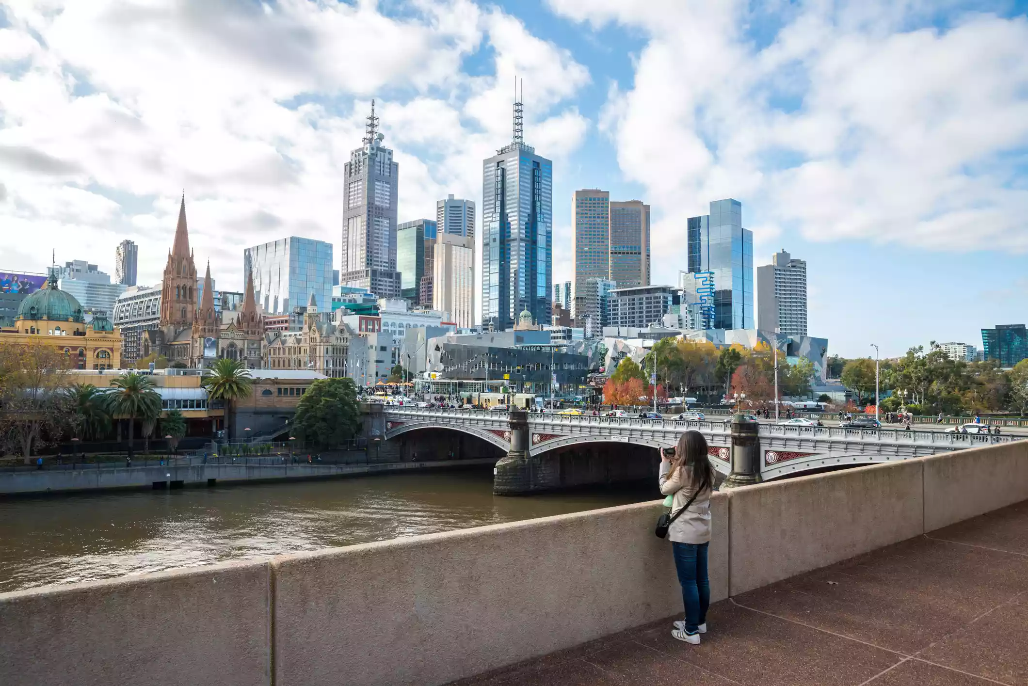 Tourists take pictures of downtown Melbourne from viewpoint