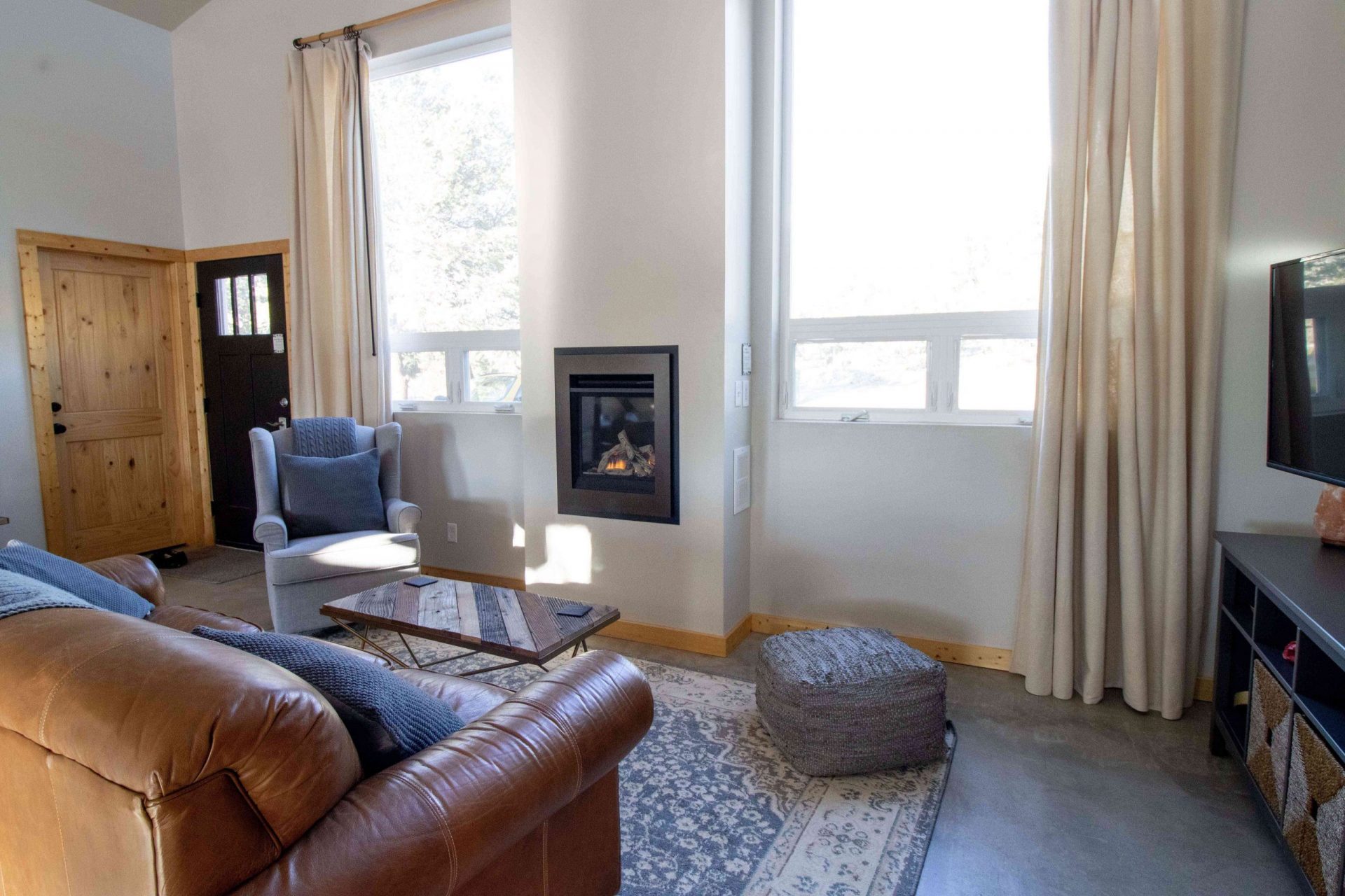 salón minimalista con chimenea empotrada y ventanas luminosas extragrandes