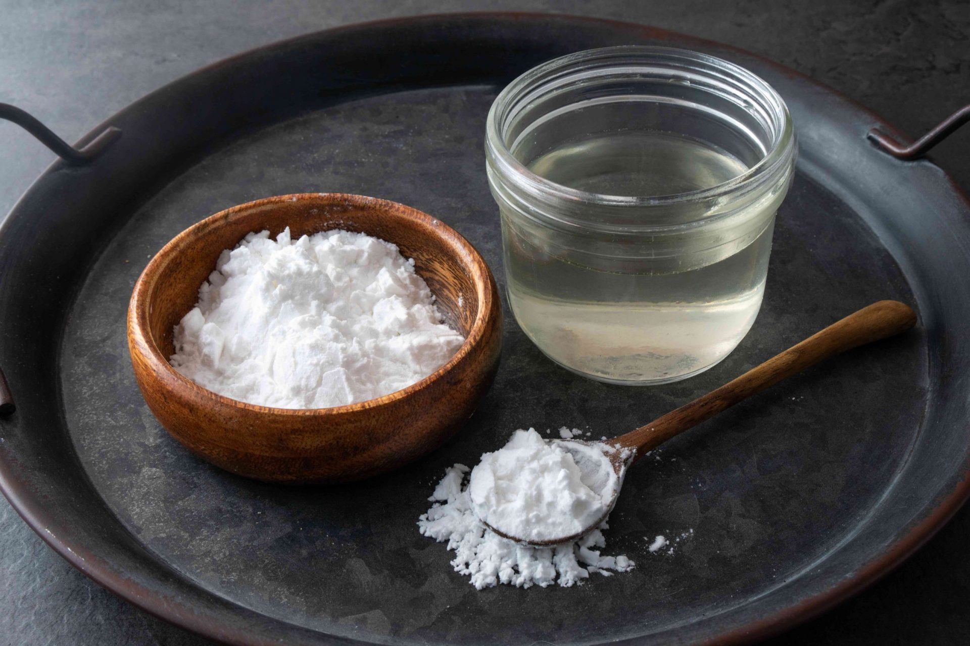 foto de producto de bicarbonato de sodio en un cuenco de madera y vinagre blanco en un tarro de cristal