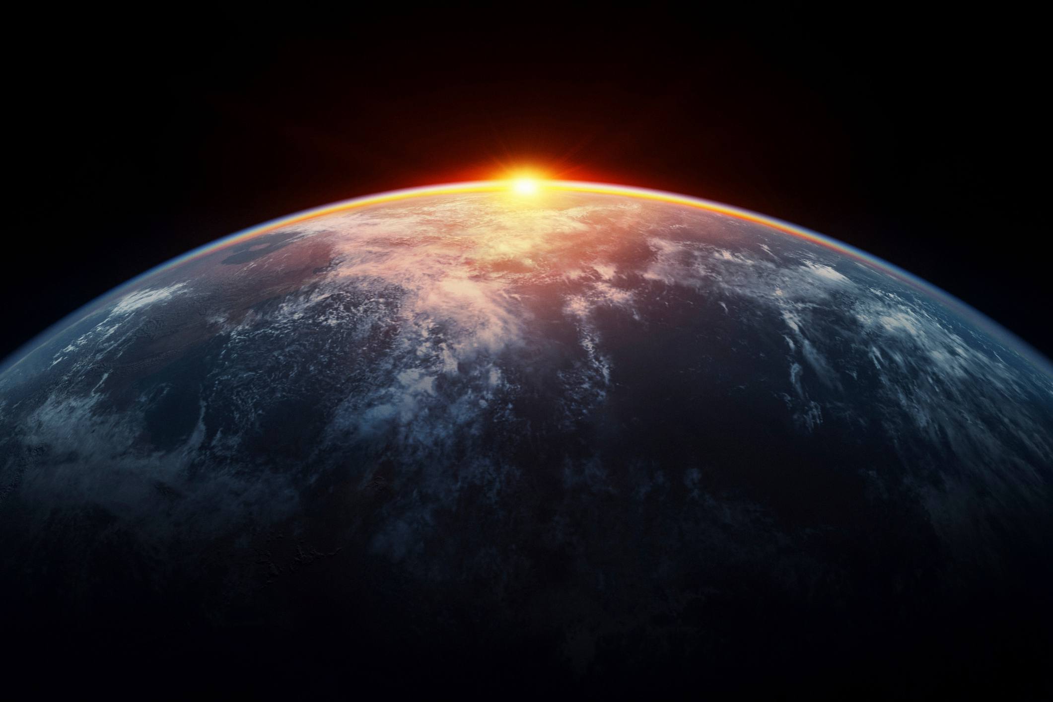 La luz del sol eclipsando el planeta Tierra vista desde el espacio