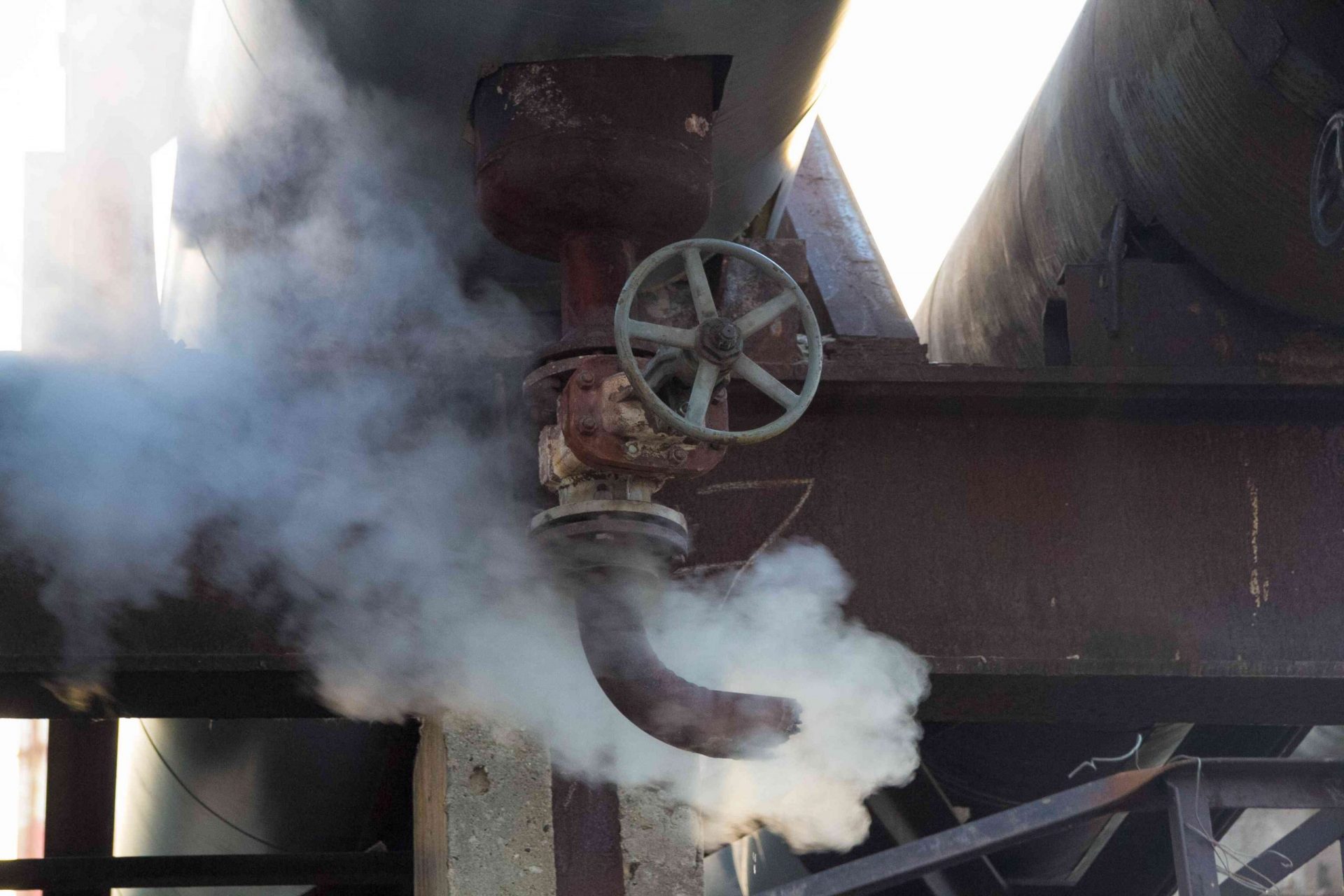 Fuga de vapor en la tubería de calor. Salida de vapor del tubo oxidado con válvula