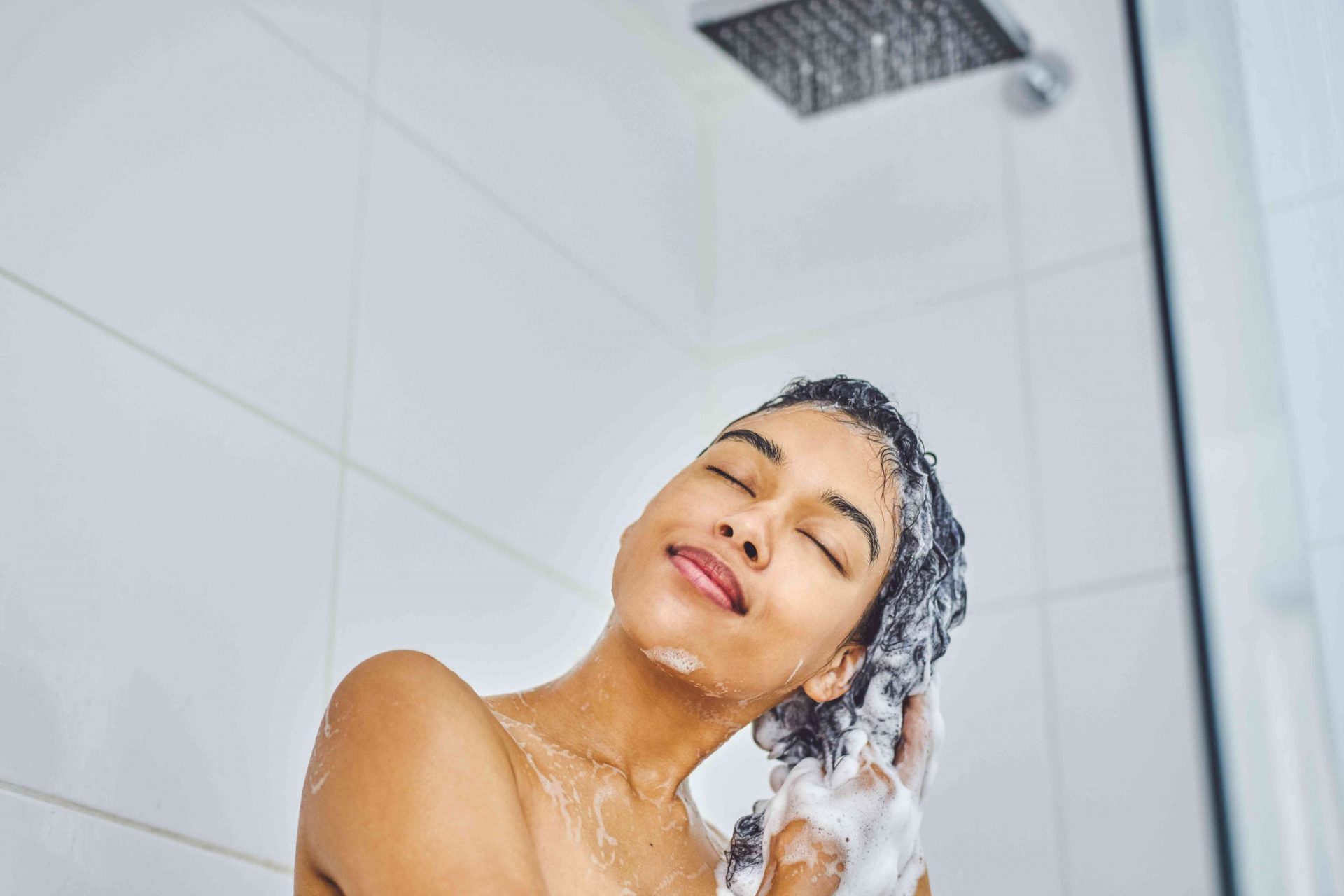 Persona lavando el pelo en la ducha
